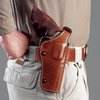 Dual Position Phoenix-holster i premium läder erbjuder starksides- eller korsdragbärande alternativ, justerbar spänning och säkerhet med förstärkt tumrem.
